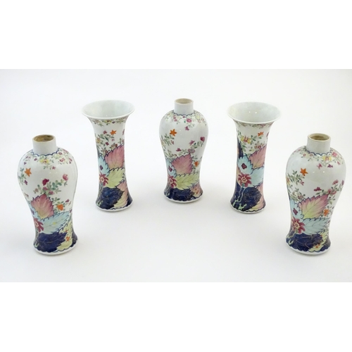 50A - Five Chinese famille rose vases comprising two trumpet vases with floral and foliate detail, and thr... 