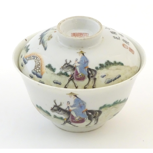 61A - A Chinese tea bowl and cover decorated with a landscape scene with a figure on horseback, a bridge a... 