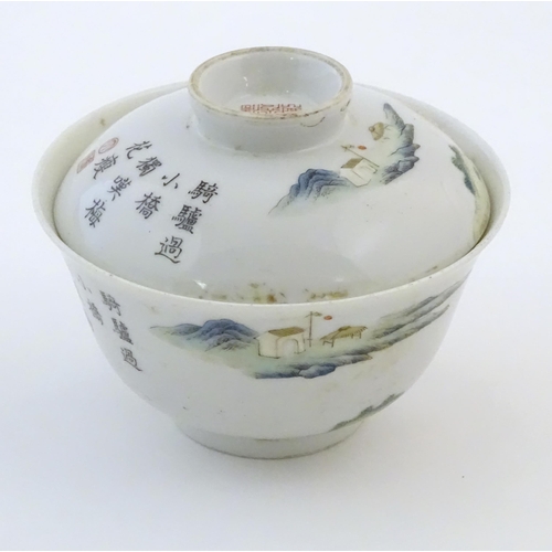 61A - A Chinese tea bowl and cover decorated with a landscape scene with a figure on horseback, a bridge a... 