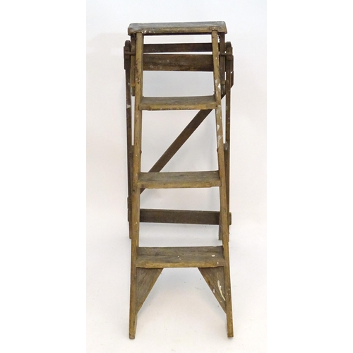 1584 - An early to mid 20thC wooden shop step ladder, latticed and folding, with metal plaque marked ' C A ... 