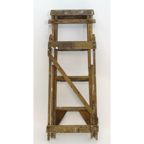 1584 - An early to mid 20thC wooden shop step ladder, latticed and folding, with metal plaque marked ' C A ... 