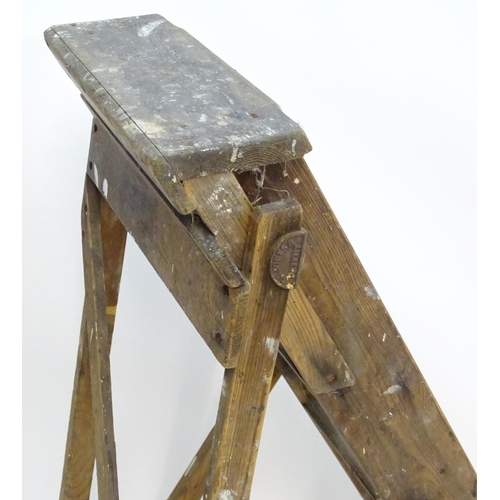 1584 - An early to mid 20thC wooden shop step ladder, latticed and folding, with metal plaque marked ' C A ... 