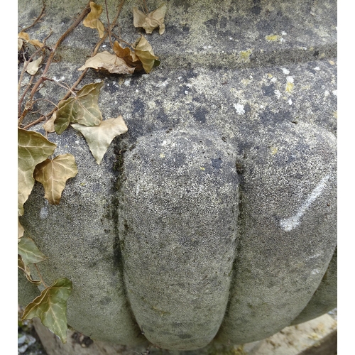 1590 - Garden & Architectural, Salvage: a pair of mid 20thC reconstituted stone urns, standing on squared b... 