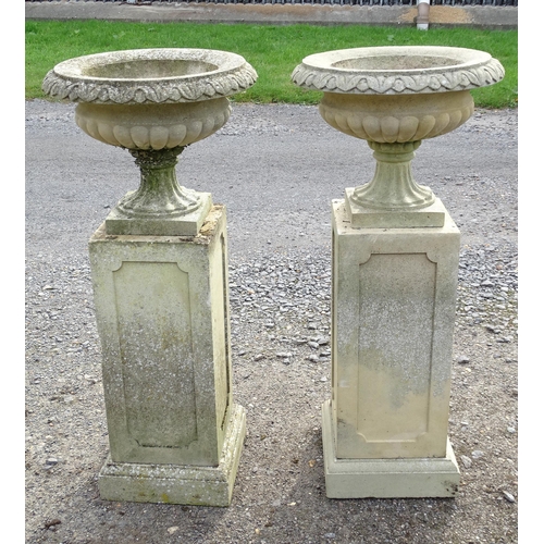 1592 - Garden & Architectural, Salvage: a pair of mid 20thC reconstituted stone classical urns, standing on... 