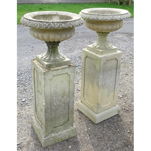 1592 - Garden & Architectural, Salvage: a pair of mid 20thC reconstituted stone classical urns, standing on... 