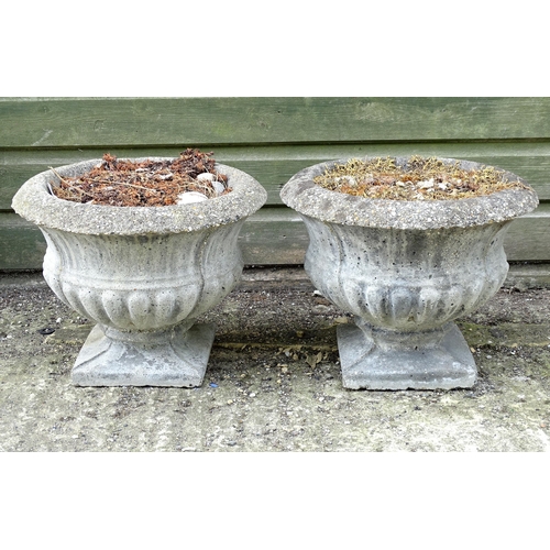 1596 - Garden & Architectural, Salvage: a pair of 20thC urns, of classical form with squared integral bases... 