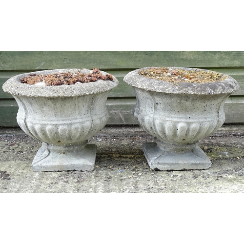 1596 - Garden & Architectural, Salvage: a pair of 20thC urns, of classical form with squared integral bases... 