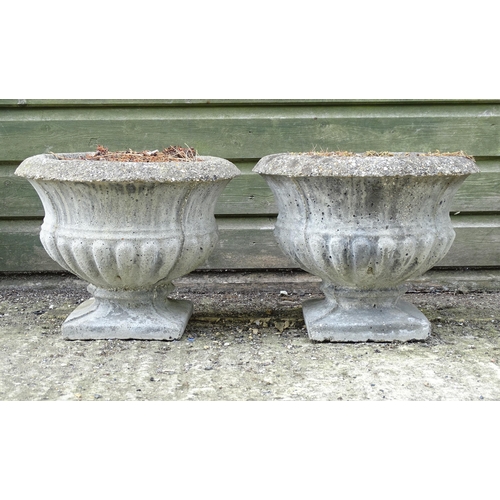 1596 - Garden & Architectural, Salvage: a pair of 20thC urns, of classical form with squared integral bases... 