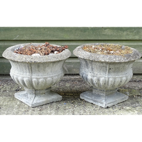 1596 - Garden & Architectural, Salvage: a pair of 20thC urns, of classical form with squared integral bases... 