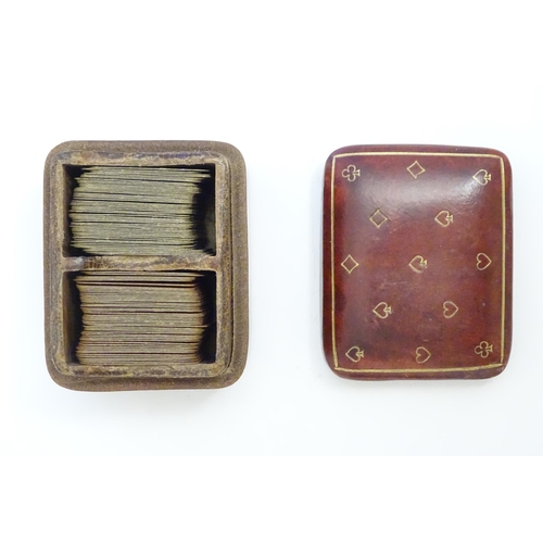 1482 - Toys: A 20thC Italian calf leather box with gilt suit symbol detail, containing small proportion pla... 