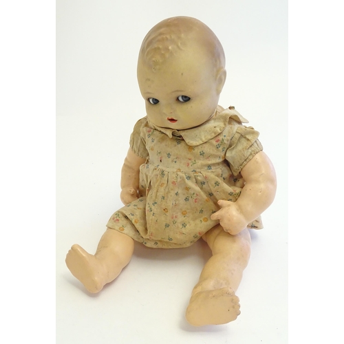 1484 - Toy: A 20thC doll with composite head, arms and legs, with blinking eyes, painted details and articu... 