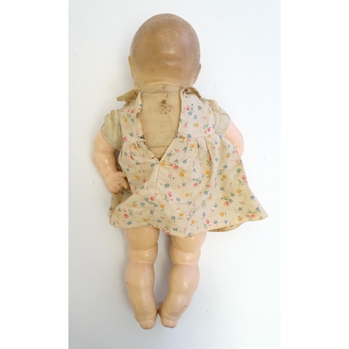 1484 - Toy: A 20thC doll with composite head, arms and legs, with blinking eyes, painted details and articu... 