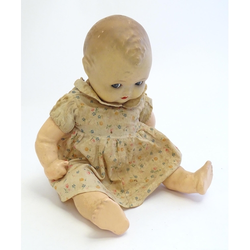 1484 - Toy: A 20thC doll with composite head, arms and legs, with blinking eyes, painted details and articu... 