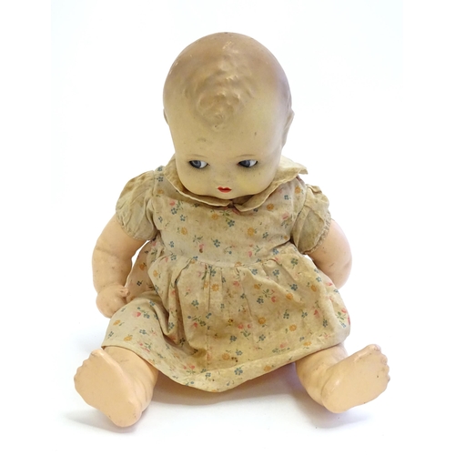 1484 - Toy: A 20thC doll with composite head, arms and legs, with blinking eyes, painted details and articu... 