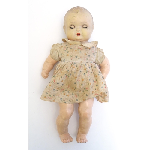 1484 - Toy: A 20thC doll with composite head, arms and legs, with blinking eyes, painted details and articu... 