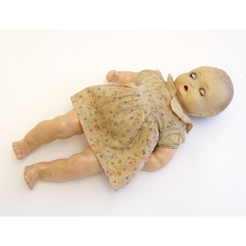 1484 - Toy: A 20thC doll with composite head, arms and legs, with blinking eyes, painted details and articu... 