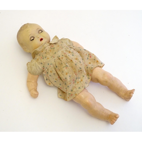 1484 - Toy: A 20thC doll with composite head, arms and legs, with blinking eyes, painted details and articu... 