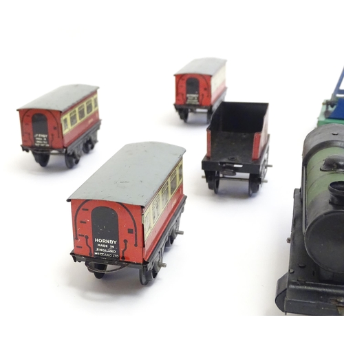 1490 - Toys: A quantity of assorted Hornby Meccano O gauge trains, to include a 4-4-0 clockwork locomotive ... 