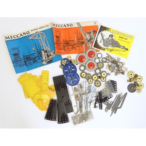 1495 - Toys: A quantity of Meccano, to include gears, brackets, wheels, struts, plates, bolts, nuts, etc. T... 