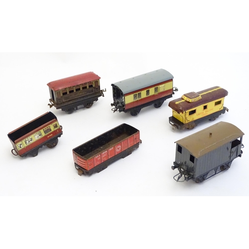 1499 - Toys: A quantity of assorted Hornby Meccano O and OO gauge rolling stock / trains and railway access... 