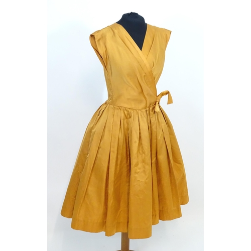 1547 - Vintage clothing / fashion: A c1950's dress in orange, with full skirt and tulle under, waist measur... 