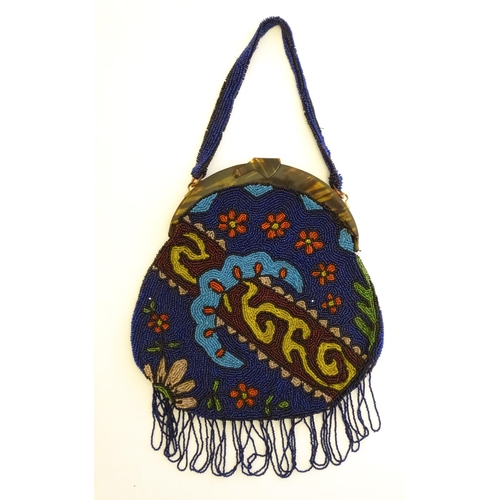 1572 - An early 20thC bead work bag / purse with stylised floral and foliate detail. Approx. 10