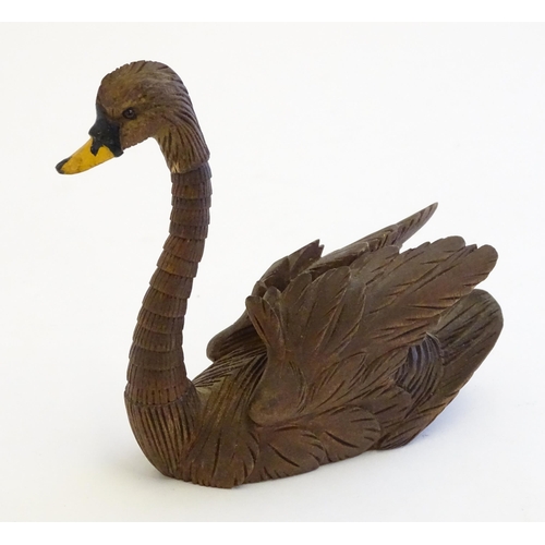 1250A - A 20thC black forest style carved pen holder modelled as a swan with an articulated neck. Approx. 4 ... 