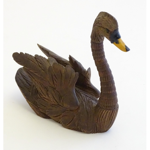 1250A - A 20thC black forest style carved pen holder modelled as a swan with an articulated neck. Approx. 4 ... 