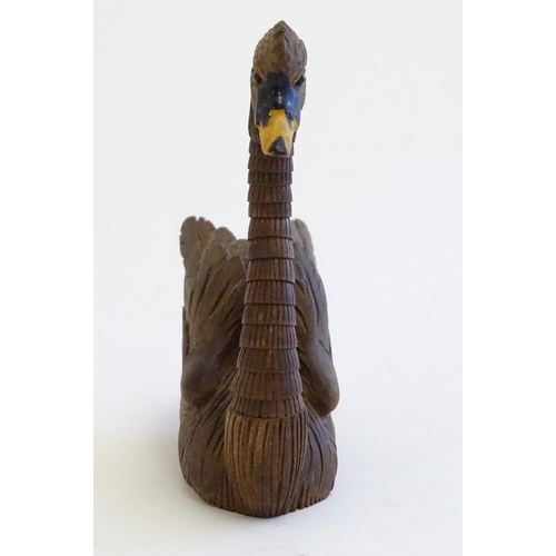 1250A - A 20thC black forest style carved pen holder modelled as a swan with an articulated neck. Approx. 4 ... 