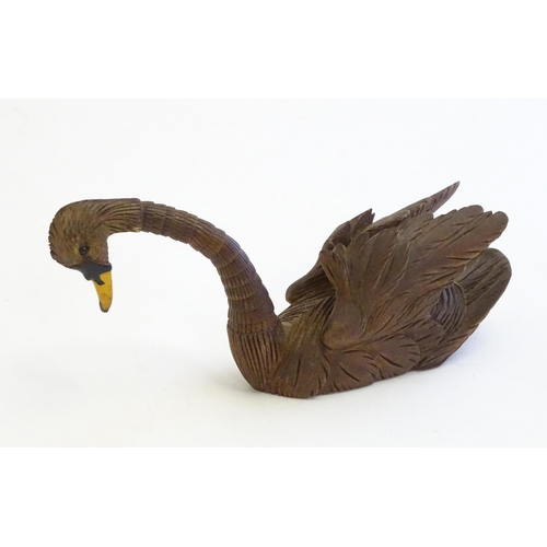 1250A - A 20thC black forest style carved pen holder modelled as a swan with an articulated neck. Approx. 4 ... 