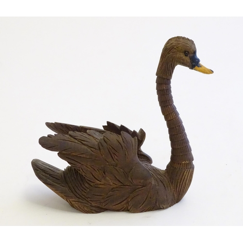 1250A - A 20thC black forest style carved pen holder modelled as a swan with an articulated neck. Approx. 4 ... 