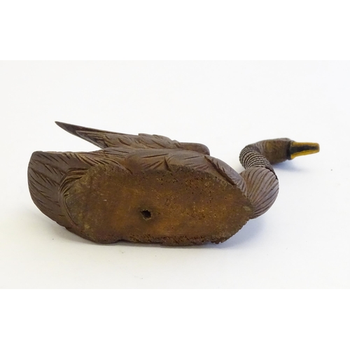 1250A - A 20thC black forest style carved pen holder modelled as a swan with an articulated neck. Approx. 4 ... 