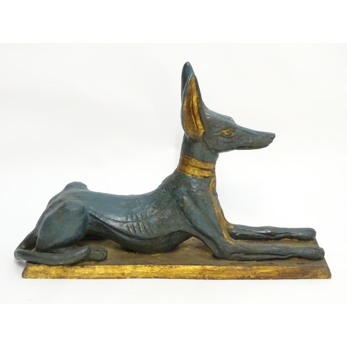 1346 - A 20thC cast terracotta model of the Egyptian deity / god Anubis, formed as a jackal dog on a rectan... 