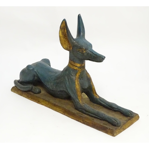 1346 - A 20thC cast terracotta model of the Egyptian deity / god Anubis, formed as a jackal dog on a rectan... 