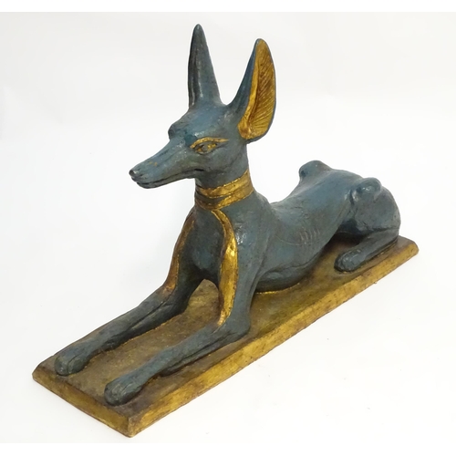 1346 - A 20thC cast terracotta model of the Egyptian deity / god Anubis, formed as a jackal dog on a rectan... 