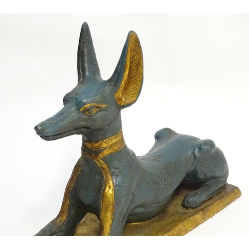 1346 - A 20thC cast terracotta model of the Egyptian deity / god Anubis, formed as a jackal dog on a rectan... 