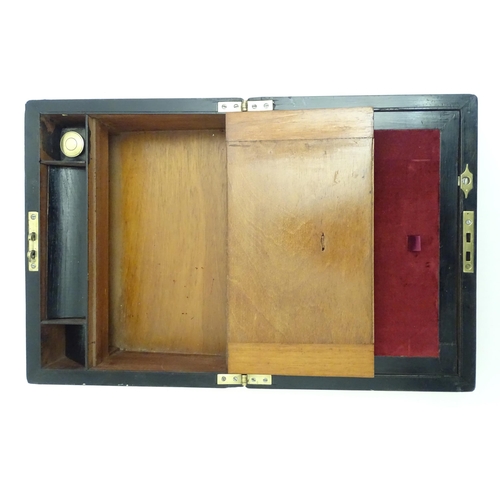 1358 - A late 19th / early 20thC walnut writing slope with brass mounts and escutcheon, the fitted interior... 