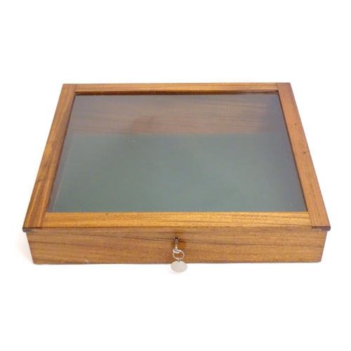 2087 - A mid 20thC mahogany shadow box with exposed dovetailing and a glazed lid opening to show a baize su... 