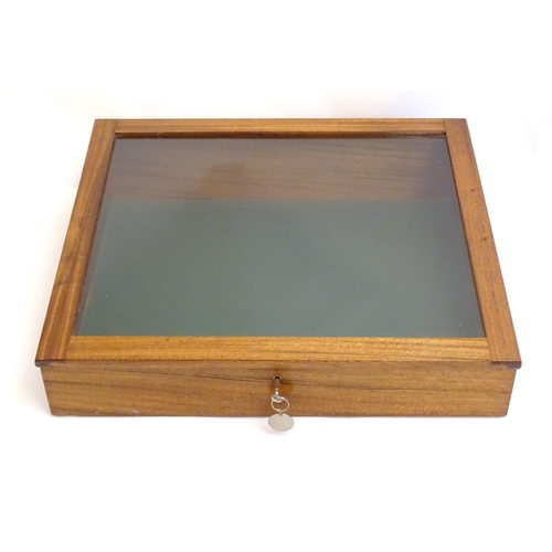 2087 - A mid 20thC mahogany shadow box with exposed dovetailing and a glazed lid opening to show a baize su... 