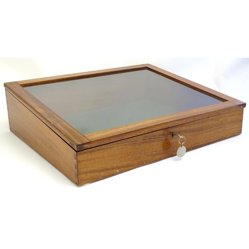 2087 - A mid 20thC mahogany shadow box with exposed dovetailing and a glazed lid opening to show a baize su... 