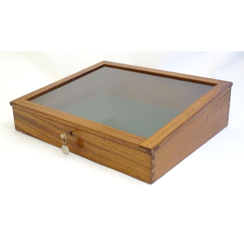 2087 - A mid 20thC mahogany shadow box with exposed dovetailing and a glazed lid opening to show a baize su... 