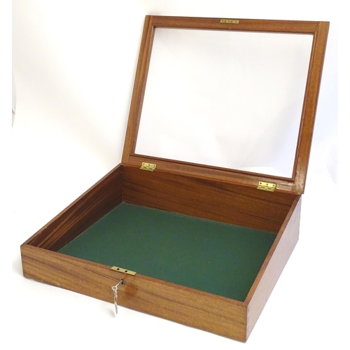 2087 - A mid 20thC mahogany shadow box with exposed dovetailing and a glazed lid opening to show a baize su... 