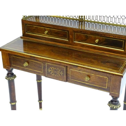 2090 - A Regency period rosewood bonheur du jour attributed to John Mclean, having a pierced brass gallery ... 