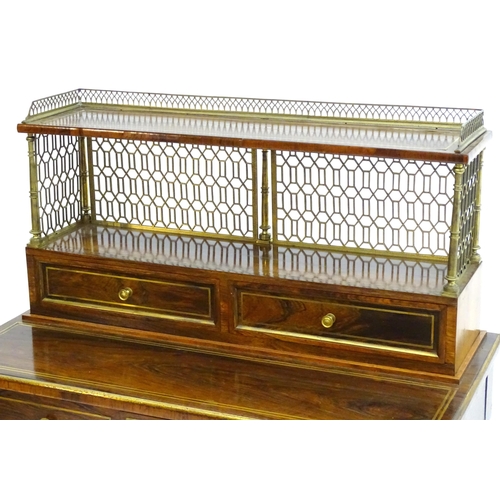 2090 - A Regency period rosewood bonheur du jour attributed to John Mclean, having a pierced brass gallery ... 