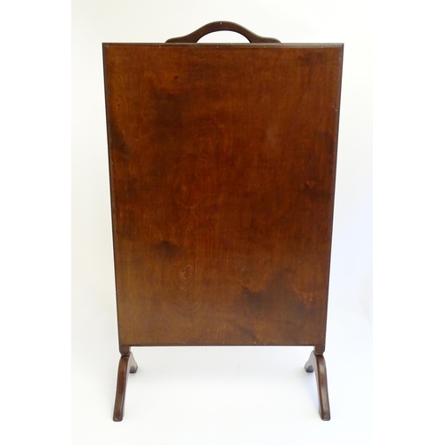 2110 - An early 20thC needlework fire screen with a mahogany frame and carrying handle to the top. 21