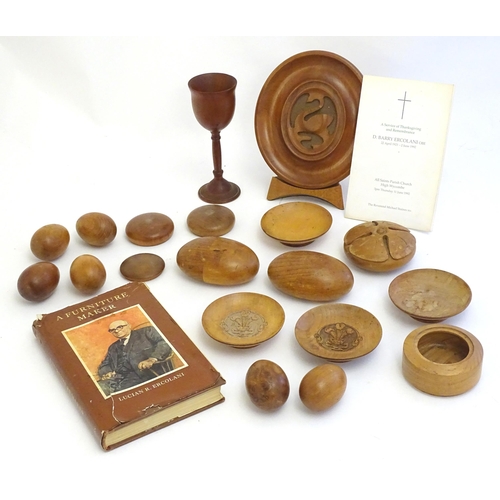 2111 - Ercol : A quantity of assorted treen turned wooden items to include models of eggs, roundel with flo... 