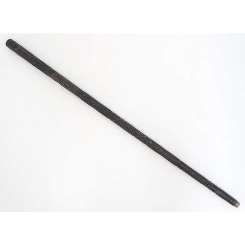 1468 - An Indian ebony walking cane / stick with carved detail. Approx. 32 1/2