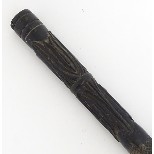 1468 - An Indian ebony walking cane / stick with carved detail. Approx. 32 1/2