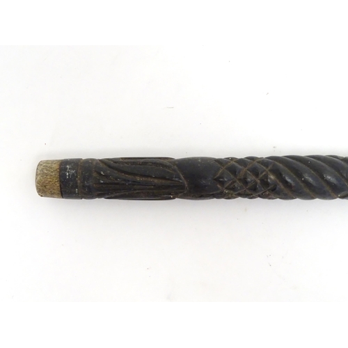 1468 - An Indian ebony walking cane / stick with carved detail. Approx. 32 1/2