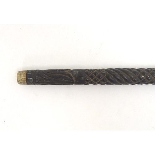 1468 - An Indian ebony walking cane / stick with carved detail. Approx. 32 1/2